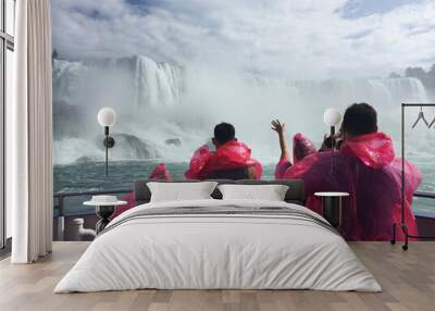 visitors to the canadian side of niagara falls wear masks while enjoying a river boat ride. Wall mural