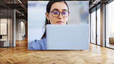 Business woman, glasses and working on laptop in office, agency and startup company. Focus, face and female worker on computer technology for email, internet planning and professional seo research Wall mural