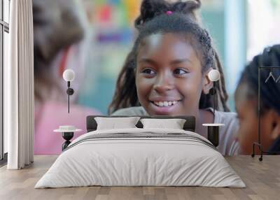 A group of young girls sharing stories and laughter while sitting closely together. Wall mural