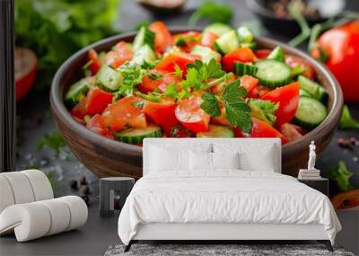 Fresh vegetable salad with tomatoes and cucumbers in a wooden bowl on a dark table, perfect for healthy meal preparation or light dining Wall mural