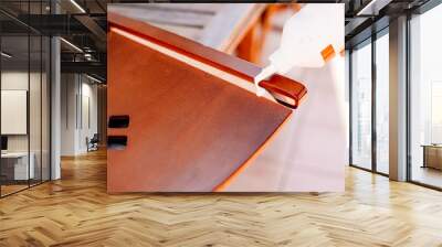 Person applies wood glue to glue loose boards from a broken chair. Wall mural