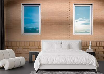 Simple brick facade with two vertical windows. Wall mural