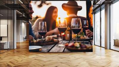 Young people enjoy a glass of wine at a wooden table in a garden. Ai generated. Wall mural