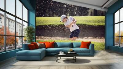 young girl playing golf on a sunny day moving sand in the banker Wall mural