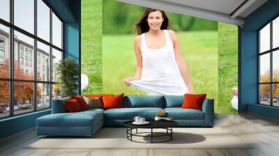 Three outdoor photos of a beautiful young woman wearing white sportswear, she is sitting on two photos and standing on the third Wall mural