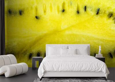 A close-up photo of the pulp of a ripe yellow watermelon with black seeds Wall mural