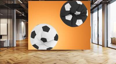 Two black and white armchairs in the form of a soccer ball on an orange background. Top view. 3d rendering Wall mural