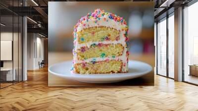 A slice of cake with rainbow sprinkles on top Wall mural