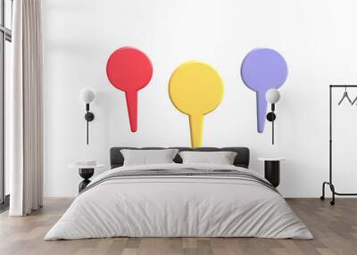 Three colorful pins in red, yellow and purple on a black background. Wall mural