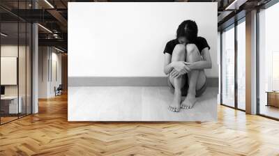 Sad woman hug her knee and cry. Patient has depression mood, low self esteem, and suicidal attempt idea from major depressive disorder (MDD). Mental health care and medical problem concept Wall mural