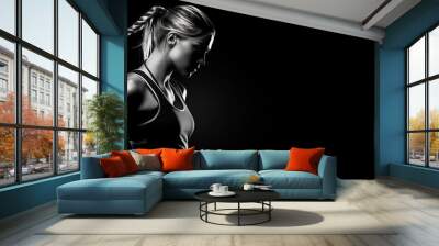 Beautiful female fitness model portrait banner with copy space.  black and white isolated on black background Wall mural