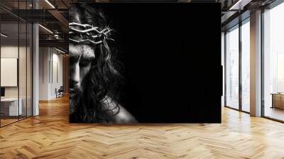 Black and white photorealistic studio portrait of Jesus Christ wearing a crown of thorns on black background. Generative AI illustration Wall mural