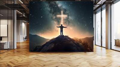 Christian cross symbol in the night sky with silhouette of person with their arms raised worshipping God Wall mural