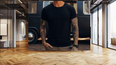 Male model posing outdoors with plain blank black canvas t-shirt mockup Wall mural