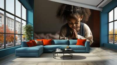 Portrait of young African American girl in prayer Wall mural