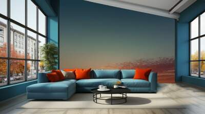 Sunset Sky: A breathtaking panorama of a vibrant sunset, capturing the sun's golden rays illuminating the clouds in a symphony of warm hues.  The sky transitions from a deep azure to a fiery orange, c Wall mural