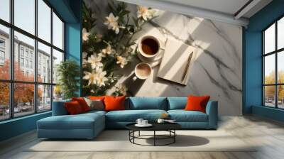 A marble table top with two cups of coffee, a notebook and pen, and a flower sprig. Wall mural