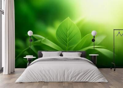 A vibrant green leaf stands out against a soft, glowing background, symbolizing growth and vitality. Wall mural