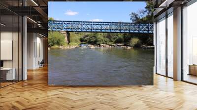 Beautiful old French railway bridge above a river. Photo was taken on a sunny day with an awesome blue sky. Wall mural