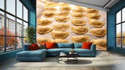 Pierogi, pirohy, filled dumplings on a baking paper, uncooked dough, Slovak dish, preparing food, cuisine Wall mural