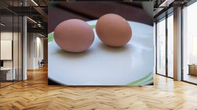 Close up of two soft boiled eggs on plate at outdoor breakfast Wall mural