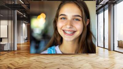 a smiling girl teenager with braces mouth, close up Wall mural