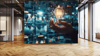 Businessman holding creative light bulb with growth graph, analytics icons. Utilizing analytics technology to develop new strategies and insights that enhance successful performance in global busines Wall mural