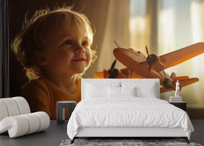 Happy child playing with toy airplane Wall mural