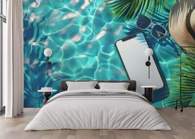 Mobile phone mockup with white blank screen laying on the blue water of the sea or pool with palm tree, sunglasses and hat Wall mural