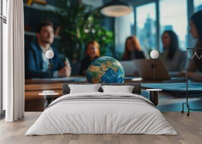 Photo of business team meeting with a globe on the table in an office, focusing on the planet Earth and blurred people at work during a conference or group business training for travel company ideas  Wall mural