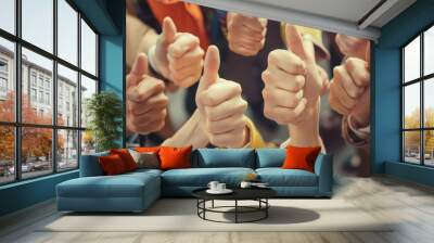 Thumbs up from a happy business team excited about the success they achieve together at work. Overhead view diverse group of corporate people excited by success and give approval to winning Wall mural