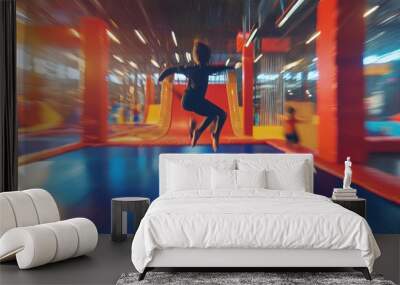 Unfocused vision of kids jumping and flipping in an indoor trampoline park. Wall mural