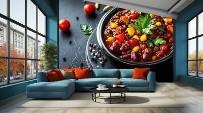 A bowl of chili with a variety of vegetables and spices on a black background Wall mural