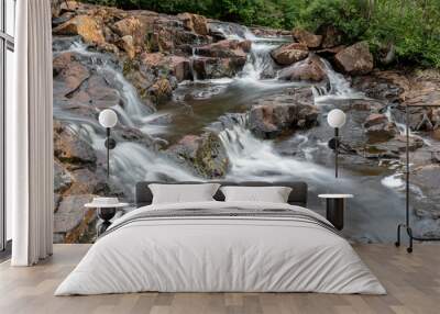 A group of small cascades is spread across the top of Mink Falls, nestled in a forest beside the Trans Canada Highway north of Lake Superior, Ontario. Wall mural