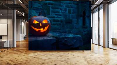 A single scary evil looking halloween Jack O Lantern on the left side of a dark blue stone plinth background of a haunted castle at night. Wall mural