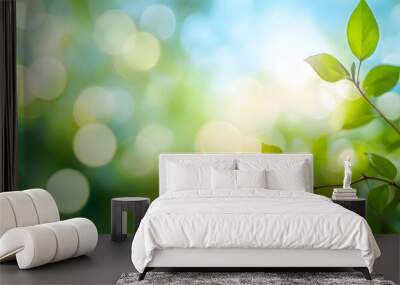 A spring, summer background of fresh lush green foliage and blue sky with blurred bokeh highlights. Wall mural