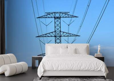 An electrical transmission tower with a distant figure walking Wall mural