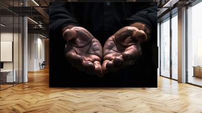 close up of male hands begging or holding something over black background Wall mural