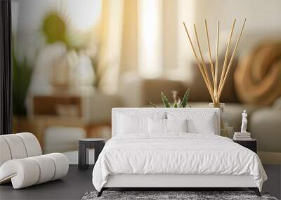 close up of reed diffuser and house plant aloe vera on wooden table in bright living room Wall mural