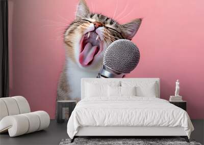 Cute cat sing a song and holding microphone isolated on pastel background studio. Wall mural