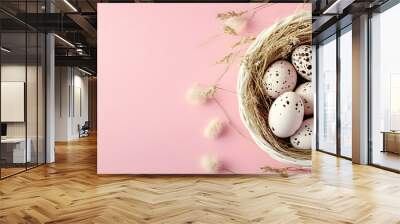 Easter greeting card with white basket of quail eggs and dry grass branch on pink background featuring copy space image for a religious themed pastel colored spring design Wall mural