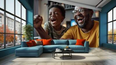 Excited african american father and adult son watching sport on tv and celebrating victory Wall mural