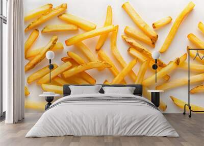 Golden crispy French fries cutouts scattered on a white background, emphasizing their crunchy texture and appetizing shape, perfect for fast food or restaurant advertisements. Wall mural