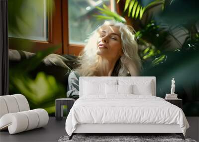 Green Home concept with relaxed stylish woman with long wavy white hair in modern sunny day at home Wall mural