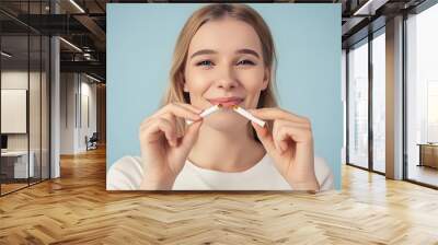 happy young beautiful woman holding a broken cigarette,quit smoking concept. Wall mural