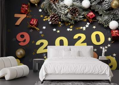 Creative frame made of Christmas fir branches on white wooden background with red decoration, pine cones. Xmas and New Year. Happy New Year 2020. Number 2020 mader theme. Wall mural