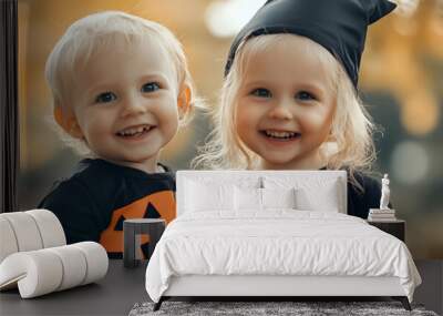 Lifestyle portrait of Happy Little caucasian siblings with blonde hair in black orange costume of which celebrating Halloween together outdoor    Wall mural