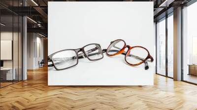 two pairs of modern of glasses isolated in a studio shot one with black and turquoise colored frames Wall mural