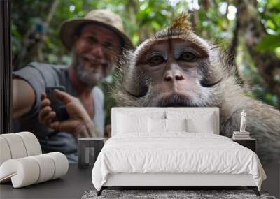 monkey with silly face selfie with a tourist man Wall mural