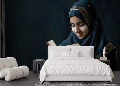 muslim girl reading a holy book quran on black background Wall mural